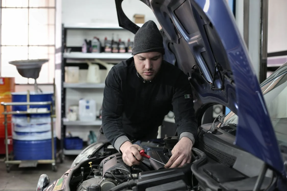 Technician checking engine oil condition using a dipstick